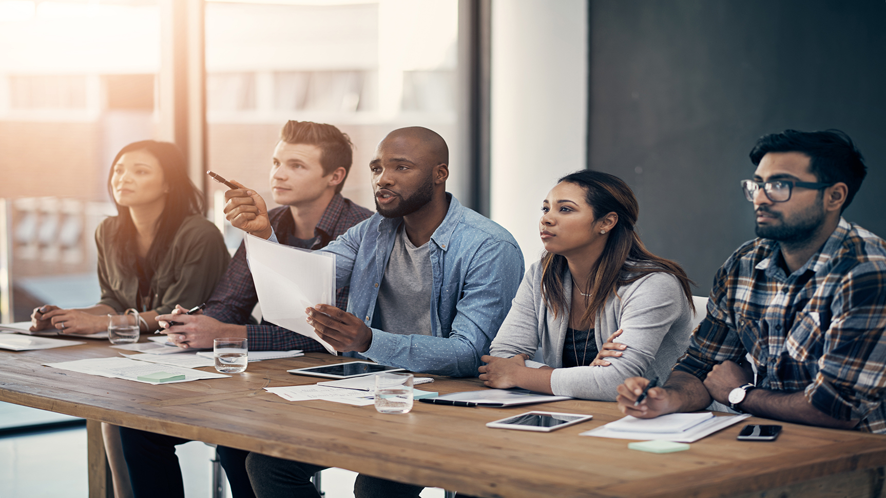 Shot of a group of young businesspeople having a meeting in a modern office