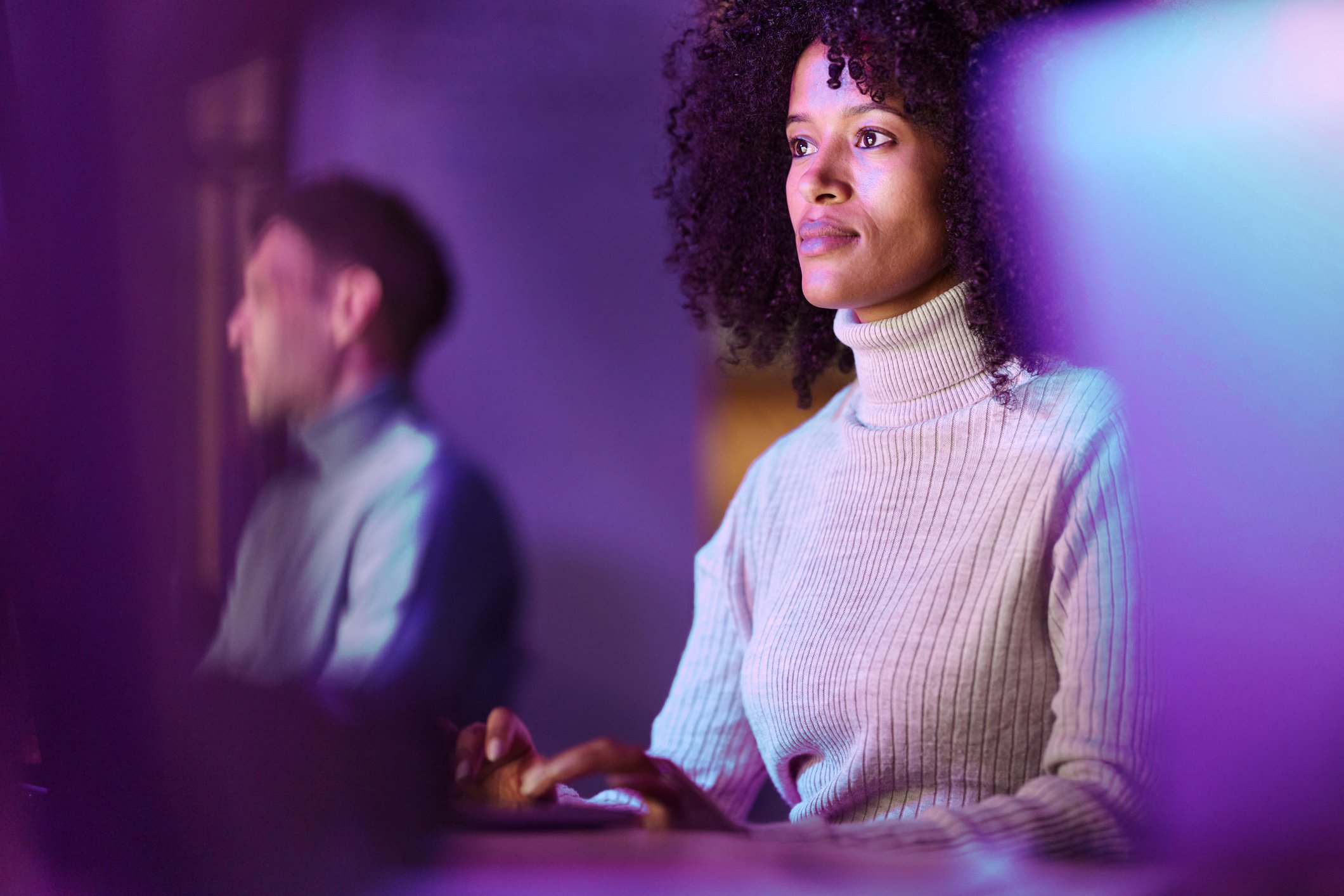 Black female programmer working on PC in the office.