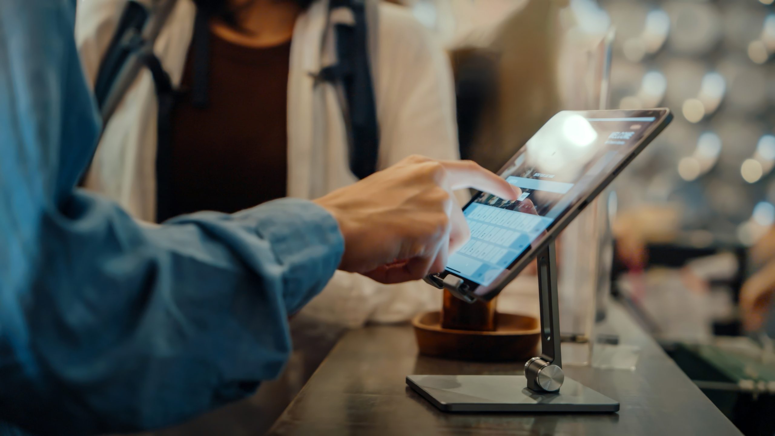 A tablet screen displays a successful self check-in at a hostel, highlighting the convenience of digital check-in services.