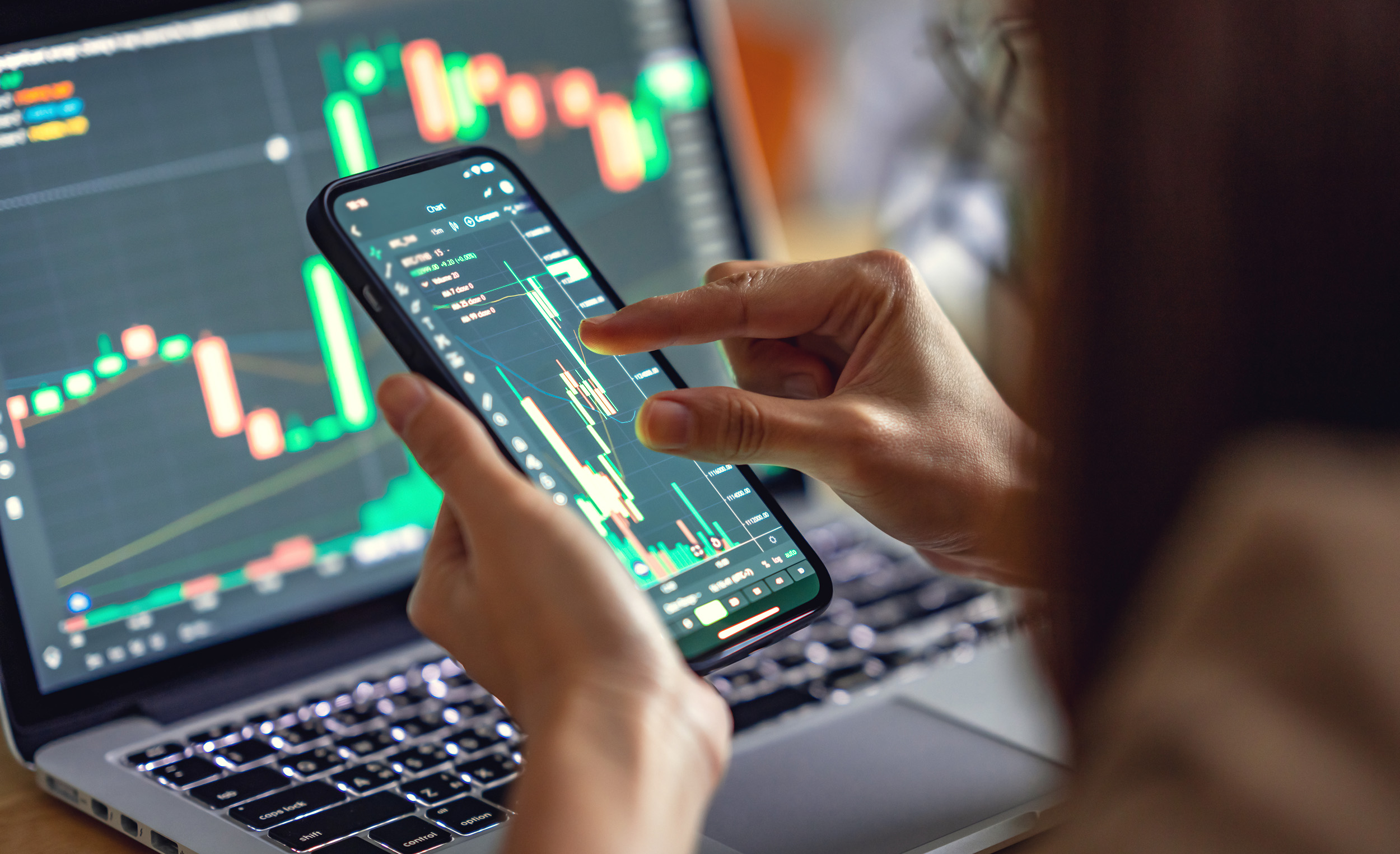 Woman is checking Bitcoin price chart on digital exchange on smartphone, cryptocurrency future price action prediction.