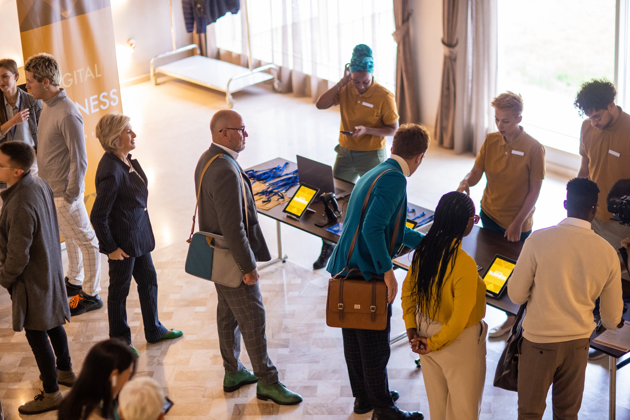 Business people registering for a conference event in a hotel lobby