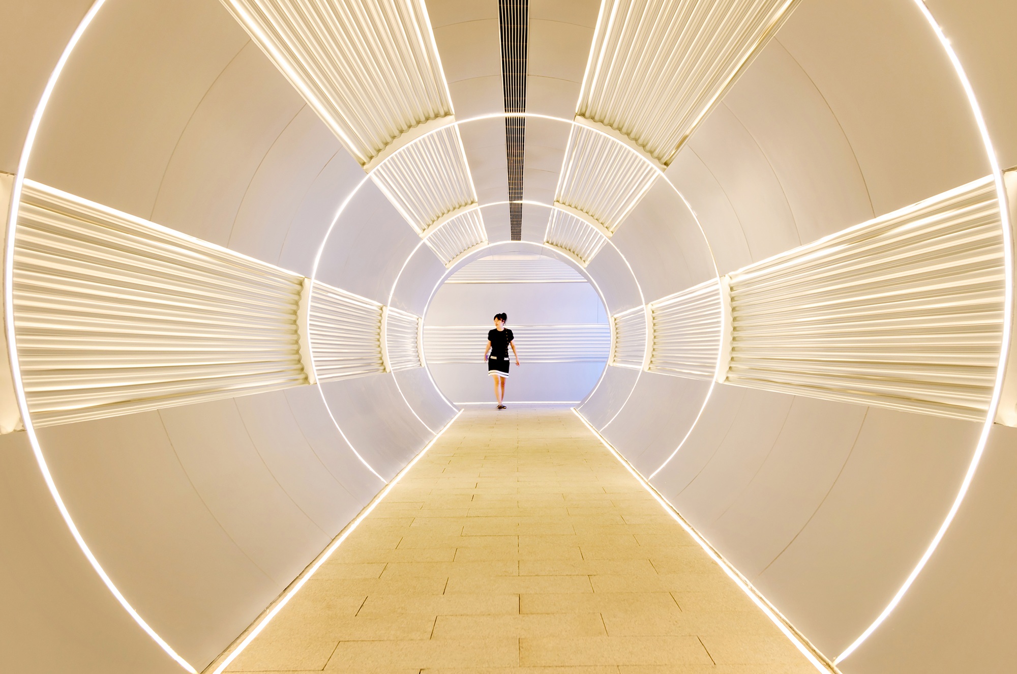 Woman walking in corridor tunnel