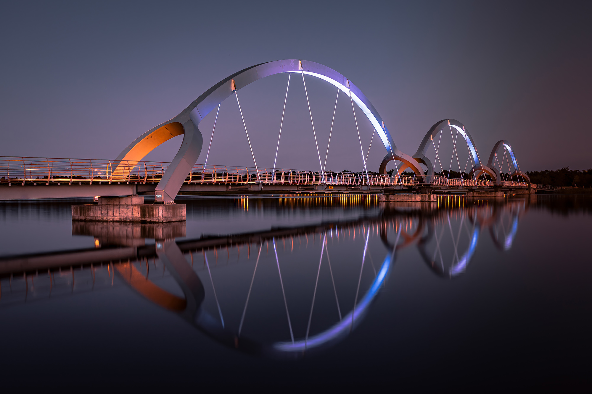 The Solvesborg bridge is 756 meters long and constructed of 600 tones steel. This is the longest pedestrian and biking bridge in Europe. Long exposure night time.