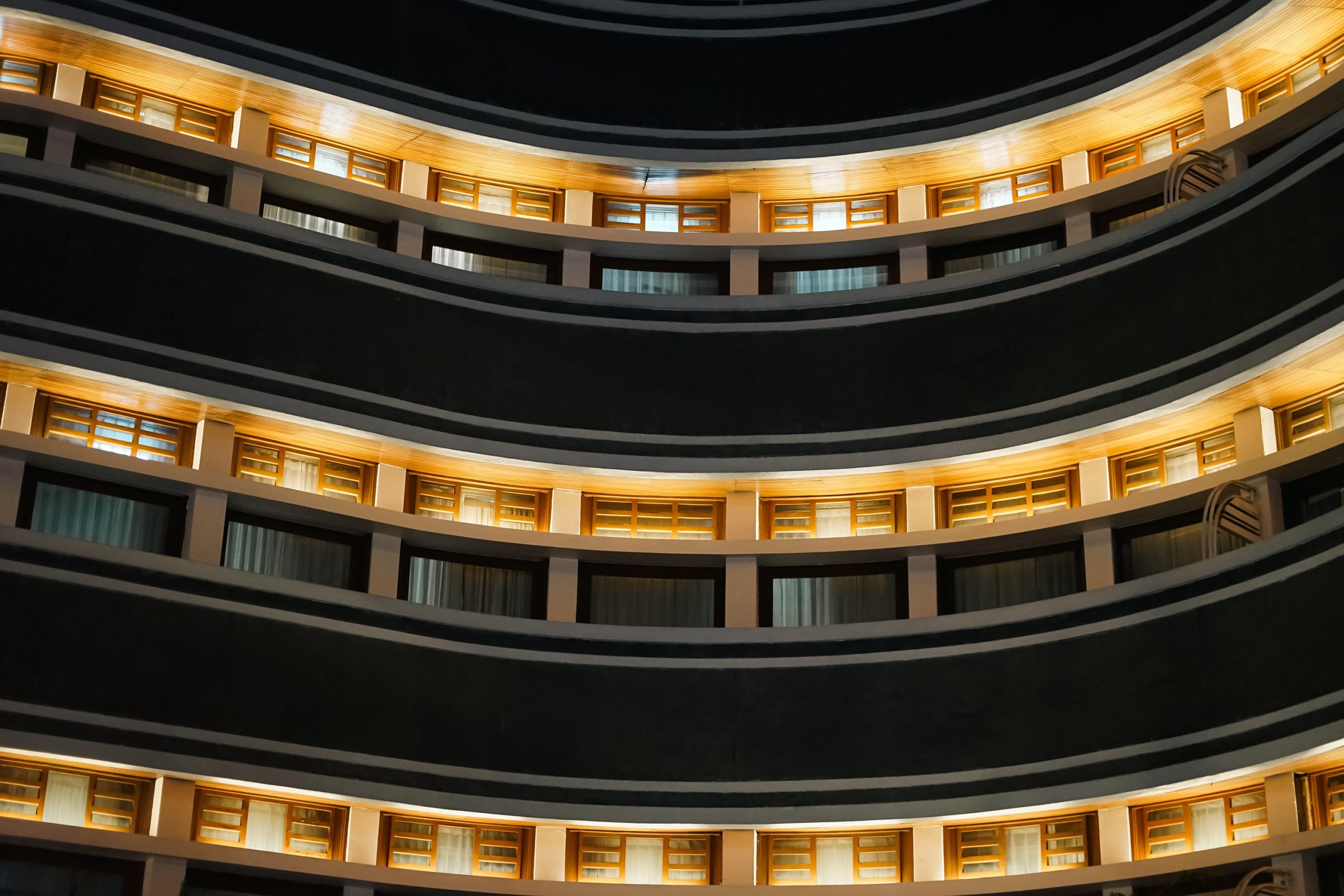 Modern hotel building curved balcony floors golden light archite