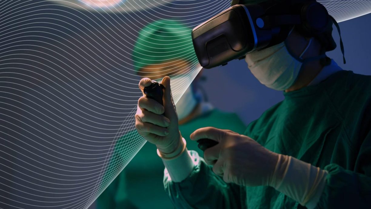 Embrace technology for a brighter future - Technology 2023 Industry Outlook. Man wearing VR headset in operating theatre